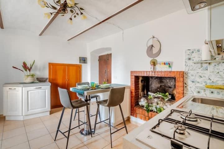 La cucina di Gabri's Home con il camino in mattoni e il tavolo alto